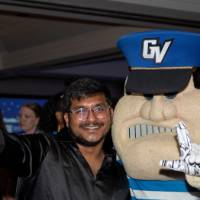 Grad does anchor up sign with Louie at Toast